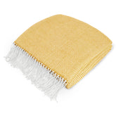 PAVILIA yellow herringbone throw draped on couch for cozy decor