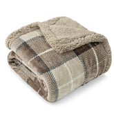 PAVILIA taupe plaid sherpa blanket on couch for cozy warmth.