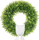Petalyn 24-inch boxwood wreath on front door with sash for year-round charm.