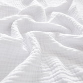 PHF muslin blanket king size on bed offering cozy coverage.