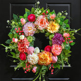 Pinkpuii Spring Wreath on front door with lush blooms for welcoming curb appeal