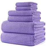 POLYTE bath towel 30x60 in waffle weave for quick drying.