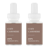Pura Cozy Cashmere bottle showcasing warm coconut-vanilla-sandalwood notes.