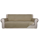 PureFit reversible quilted sofa cover top view shows soft beige fabric and plush padding.