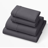 Purple SoftStretch sheets in stormy grey on bed show adaptive fit