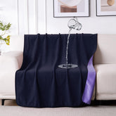 QiyI waterproof blanket on bed and couch protects surfaces from spills.