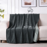 QiyI waterproof blanket on bed shows dual-tone design and spill protection.