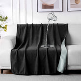 QiyI waterproof blanket on a bed keeps the surface dry and protected.