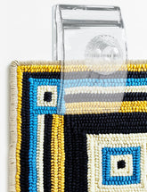 Quiltera tapestry hangers on wall display quilts clearly with unobtrusive clips.