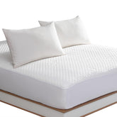Reaks king-size mattress protector bed-fit view showing snug fit up to 18 inches.