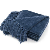RECYCO blue fringe throw blanket draped over sofa for cozy seating