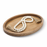 Relaxing Garden oval wood tray showcases a chic coffee table centerpiece and organized surface.
