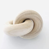 Rool chain-link wood knot decor on coffee table adds an organic focal point.
