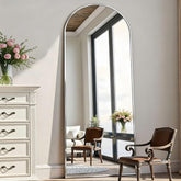 Rowjut arch floor mirror shows full body in silver, ideal for outfit checks.