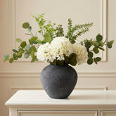 RyddeligHome faux arrangement featuring eucalyptus and hydrangea as a durable table centerpiece.