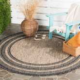 SAFAVIEH Courtyard round natural black rug for patio with durable outdoor performance
