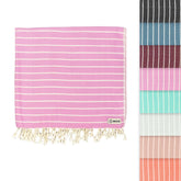 Sand Cloud Gocek Pink Turkish Beach Towel on sandy beach for comfortable sun days.
