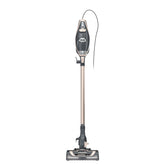 Shark Rocket Pro DLX corded stick vacuum with LED headlights illuminating debris on hardwood
