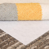 Slip-Stop Magic Stop rug pad on carpet keeps area rug in place and reduces shifting.