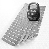 SlipX Solutions weighted bath mat on textured tub surface stays put for safer baths.