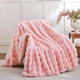 Smoofy blush pink bubble texture blanket on a sofa adds chic warmth.
