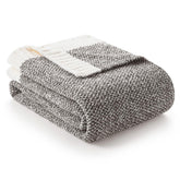 Snuggle Sac grey throw blanket with soft-knit texture for cozy sofa moments.
