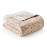 Snuggle Sac Heather Throw Blanket draped on a couch for cozy evenings