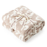 Snuggle Sac leopard throw blanket on couch adds cozy style and warmth.