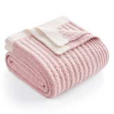 Snuggle Sac Spring Pink Throw on sofa for a cozy evening