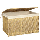SONGMICS storage basket with lid near bed for dust-free blanket storage.