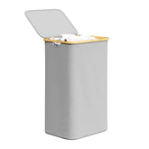 SpaceAid laundry hamper with lid and bamboo handles for tidy bedrooms and odor control.