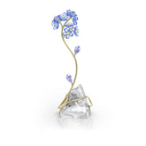 Swarovski Florere Forget-Me-Not figurine with multicolored crystals sparkles on a shelf