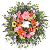 TechKen spring wreath on front door showcases vibrant blooms for welcoming curb appeal.