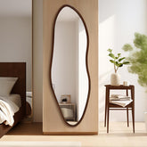 TheiaMo irregular full-length mirror in walnut provides a full-body view for living spaces.