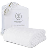Threadmill luxury cotton blanket with herringbone weave on bed for cozy warmth
