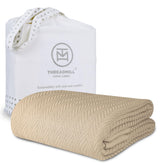 Threadmill luxury cotton blanket on king bed offers all-season warmth.
