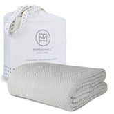 Threadmill luxury cotton blanket close-up shows herringbone weave for soft warmth.