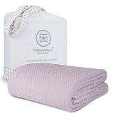 Threadmill luxury cotton blanket in lilac with herringbone weave for cozy warmth.
