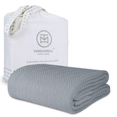 Threadmill luxury cotton blanket on king bed—all-season warmth and softness.