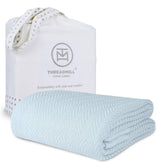 Threadmill luxury cotton blanket on a queen bed highlighting herringbone texture for all-season comfort