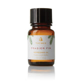 Thymes Frasier Fir Refresher Oil bottle delivering a crisp pine aroma for cozy spaces.