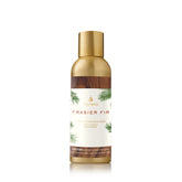 Thymes Frasier Fir mist bottle delivers piney freshness for a cozy winter vibe in your living room.