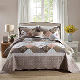 Travan quilt-queen-rose-floral-patchwork adds cozy focal point.