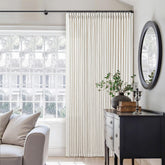 TWODRAPES memory shape-trained pinch-pleated linen curtains add tailored privacy in a living room.