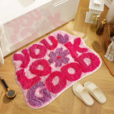 TWWDE AUG You Look Good bath rug with pink flower design adds cheerful style to your bathroom.