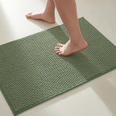 TYUU sage-green bath rug with non-slip backing keeps feet safe.