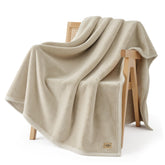 UGG Coco Plush Blanket folded on bed, adds soft warmth to nights