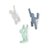 Umbra Buddy wall hooks set of three mounted on wall for stylish storage.