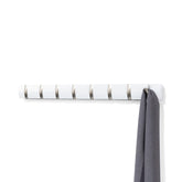 Umbra Flip 8-hook wall-mount coat rack in white-nickel for space-saving entryways.