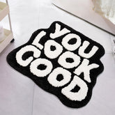 UNIBATH You Look Good Bath Mat in black and white, stylish 25x21 rug for baths.